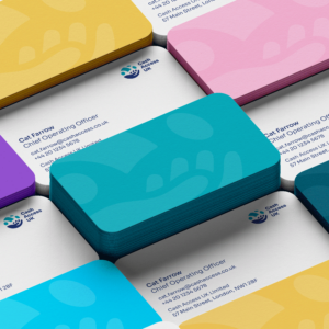 Stacks of multicoloured business cards, branded using the visual identity and logo of Cash Access UK.