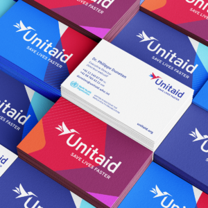 Stacks of colorful business cards for Unitaid, a global health initiative that works to end epidemics and save lives. The business cards use brand graphics and colours developed by 400 in the new Unitaid visual identity.